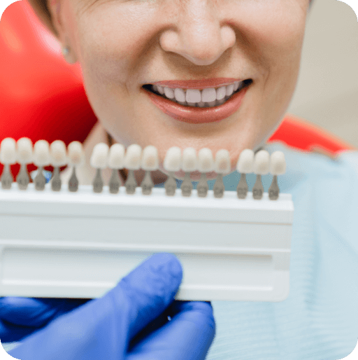 Charlotte cosmetic dentist matching veneer shade before tooth shaving procedure.