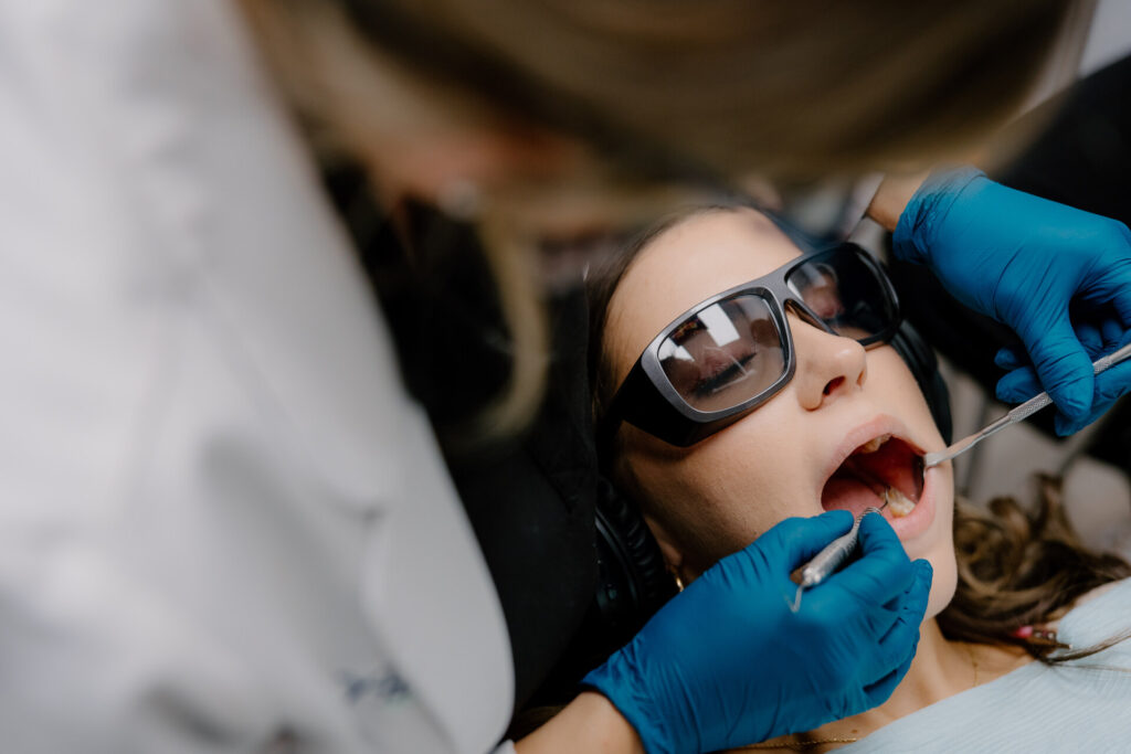 Dentist performing a dental cleaning and exam