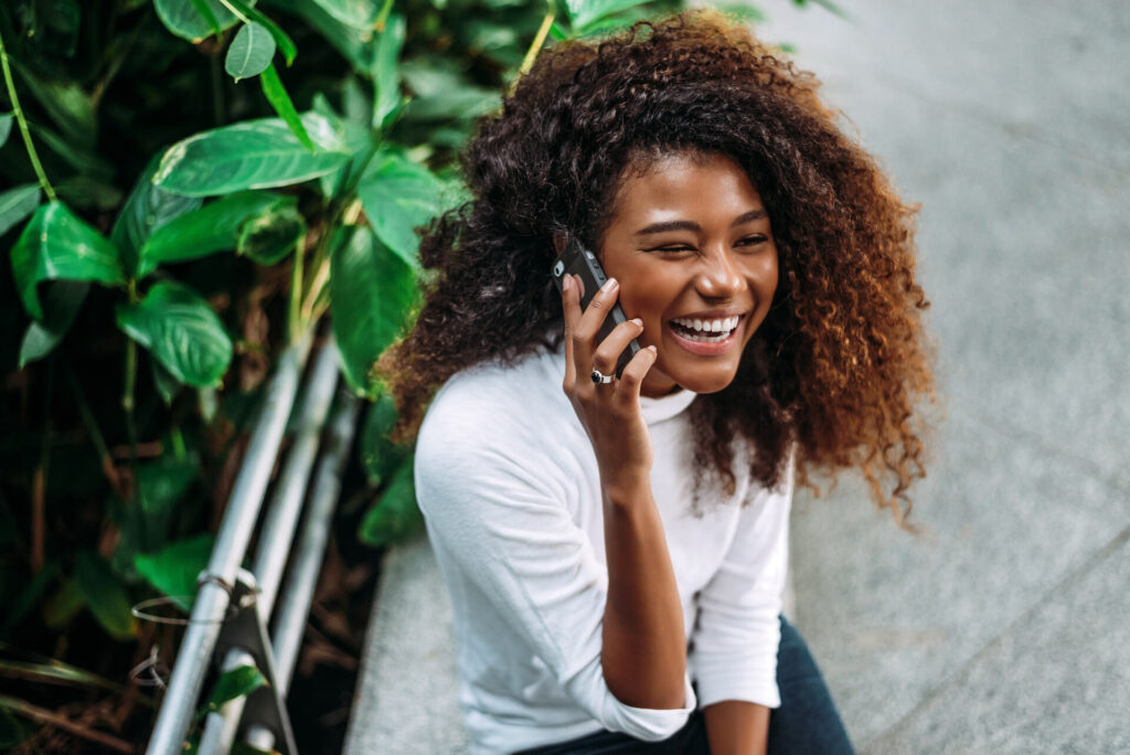 A smiling woman talking on the phone
