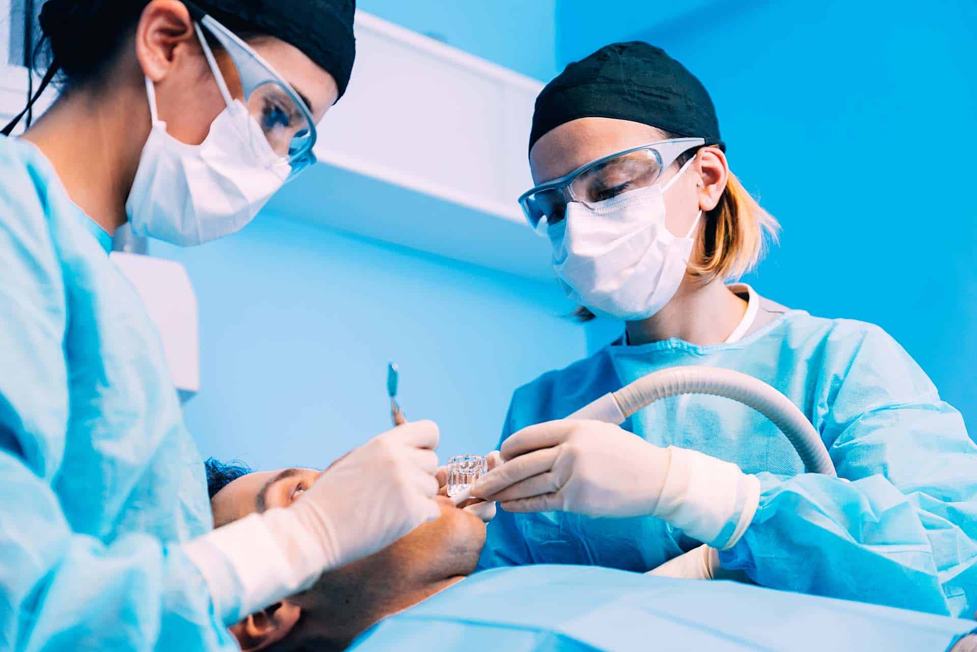 Dentists with a patient during a dental intervention. Dentist Concept