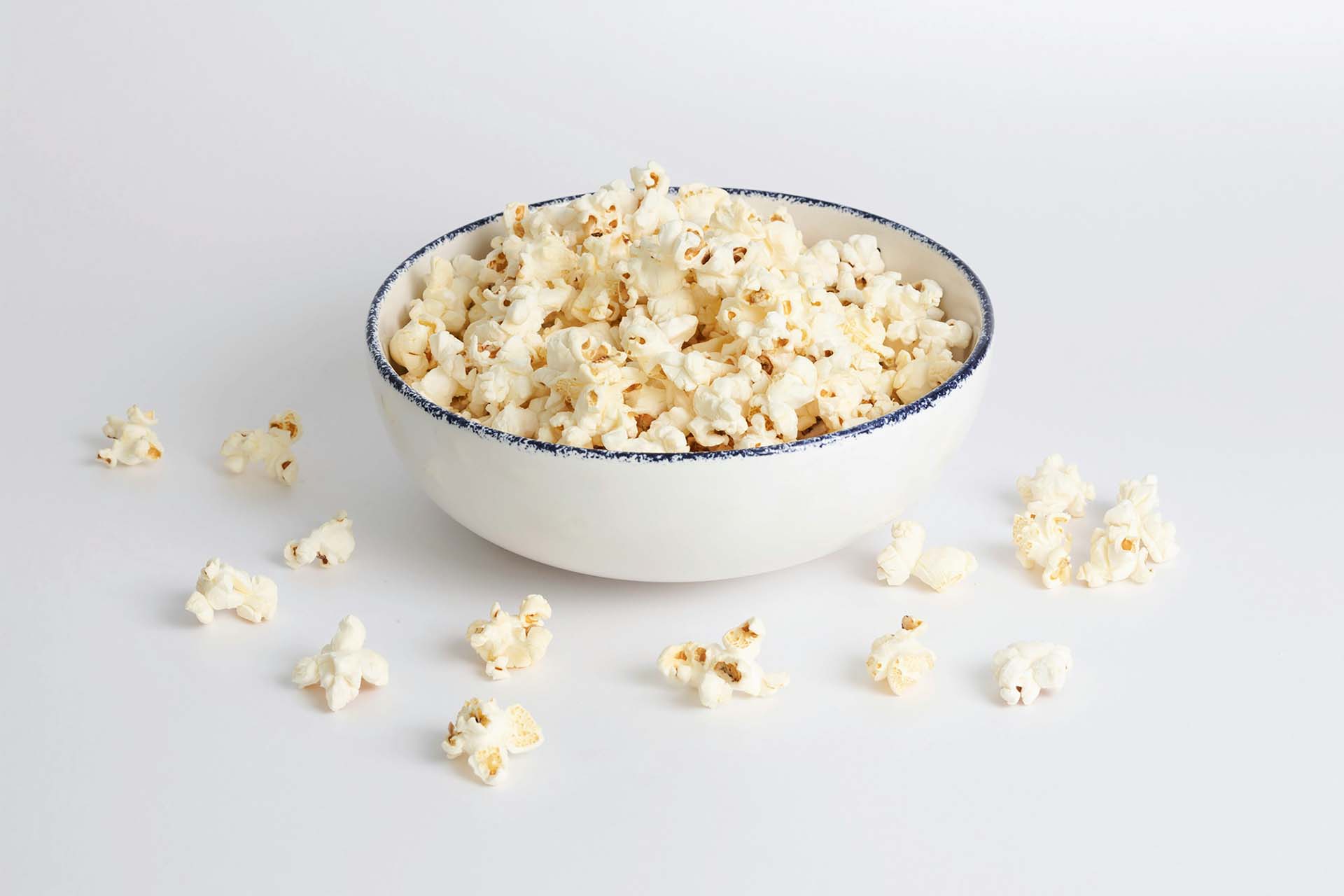 A white bowl with popcorn