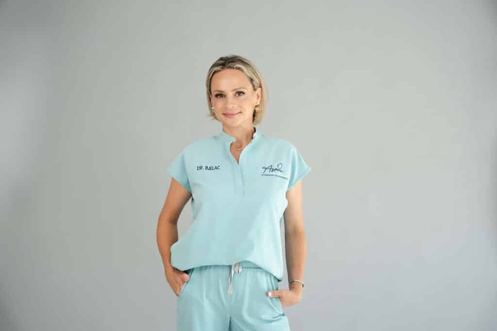 Dr. Sladjana Bjelac in front of the Aspire Dental Wellness logo
