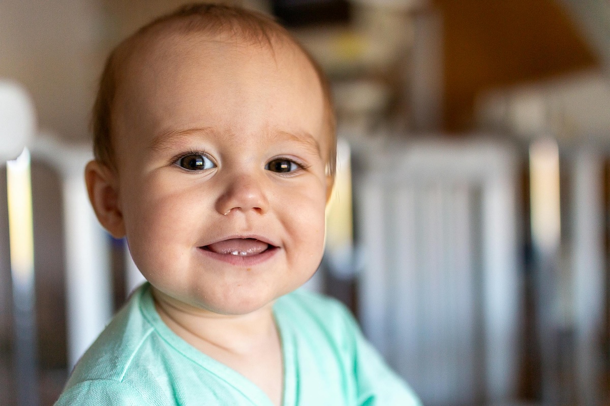Happy infant smiling after tongue tie treatment at Aspire Dental Wellness in Charlotte, NC
