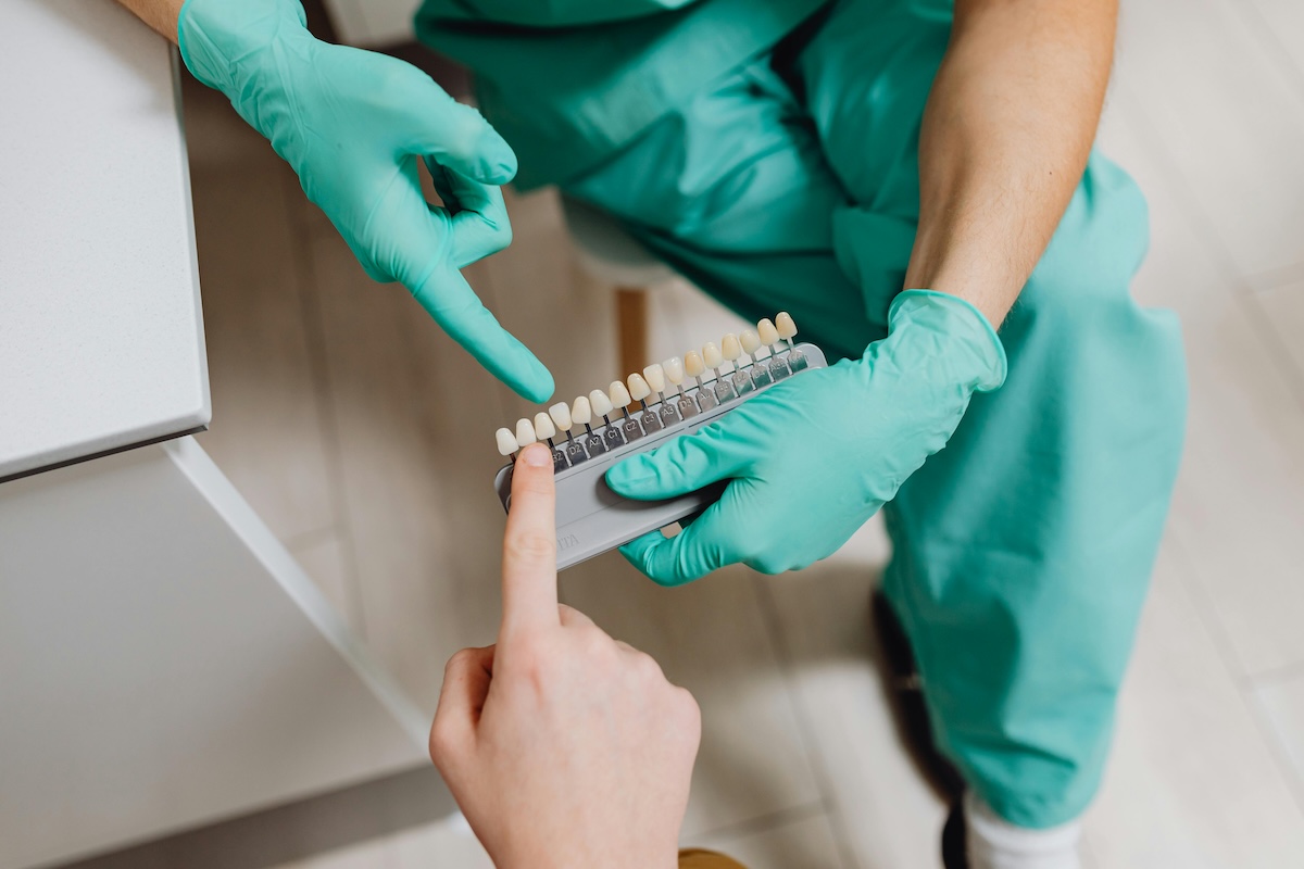 Dentist Matching Tooth Shade for Veneers with Patient